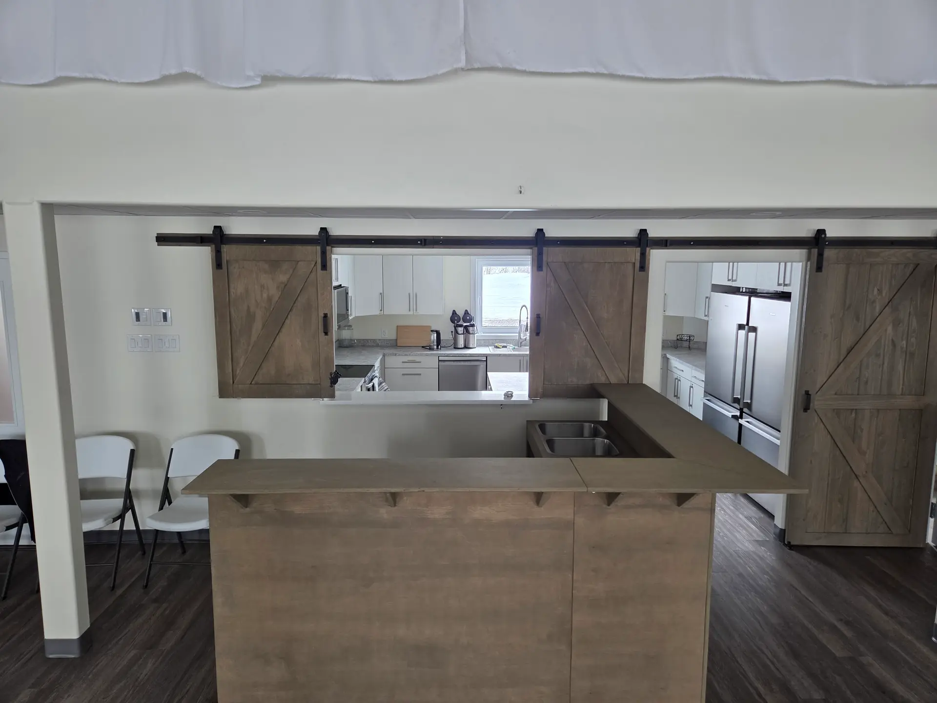 The rolling bar backed onto the kitchen pass-through, with the barn doors open